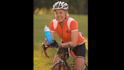 Woman on bike with sports bottle