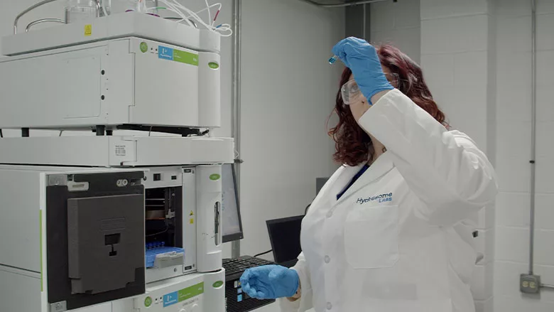 Hydrosome Labs Technician inspects vial