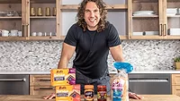 Rudis Sandos on counter with man
