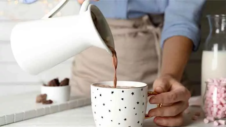 OWYN Hot Cocoa Pouring from Pitcher