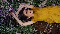 Women Laying Among Flowers 