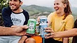 People Cheers Cans of Beer