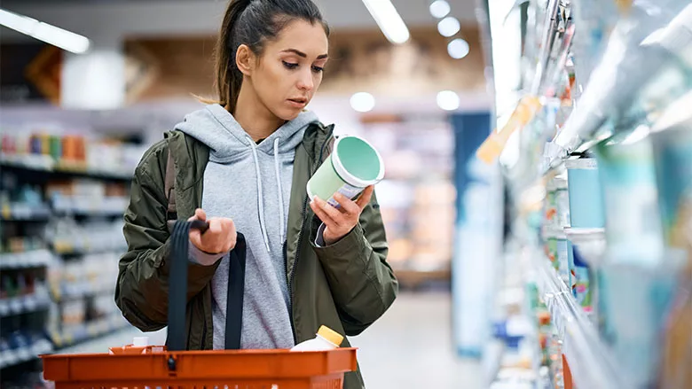 Woman Inspecting Package Grocery