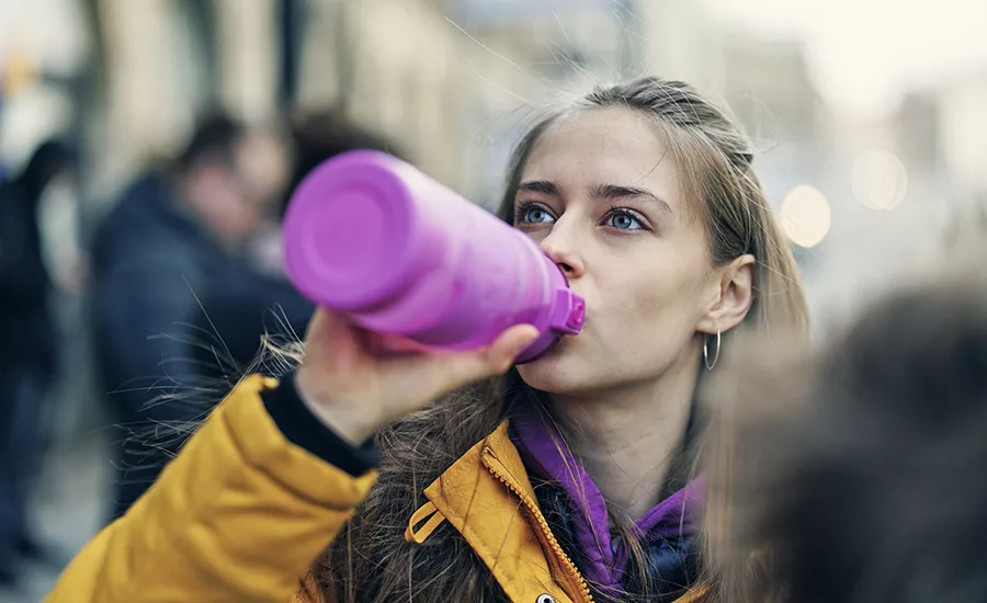 Person drinking sports beverage