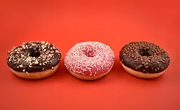 Three Donuts Orange Background