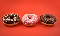 Three Donuts Orange Background