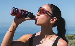 Person drinking Ka-Ex from bottle
