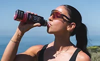 Person drinking Ka-Ex from bottle
