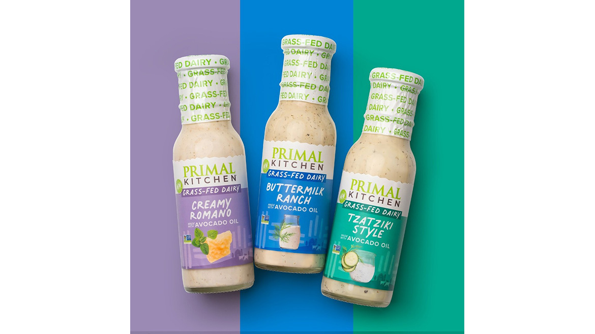 Three grass-fed dairy salad dressings, including creamy Romano, buttermilk ranch, and tzatziki-style varieties, displayed in glass bottles.