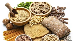 Whole-grain foods including bread, pasta, oats, cereal, and legumes.