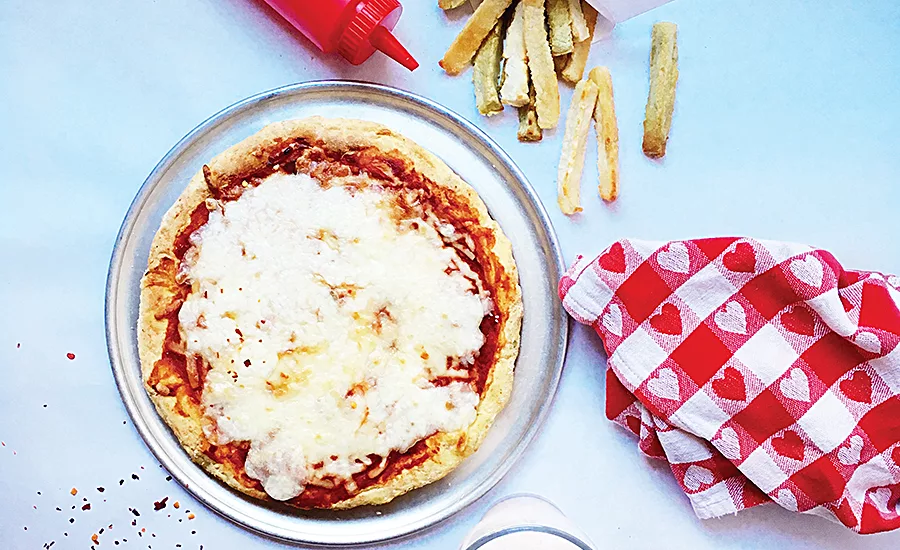 Incorporating full servings of veggies in classic foods, such as pizza, help bridge the gap between what kids should eat and what they want to eat