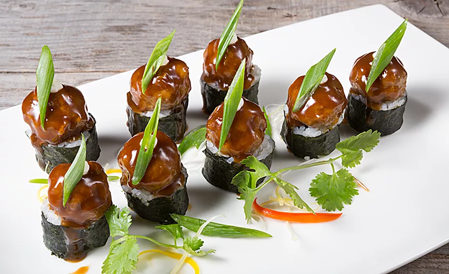 The fusion of different cuisine ingredients and styles is beginning to transition from restaurant kitchens to meals and snacks for the mainstream