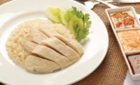 Plate of Hainanese Chicken Rice Next to Dipping Sauces