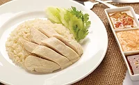 Plate of Hainanese Chicken Rice Next to Dipping Sauces