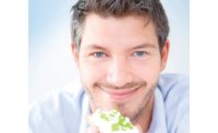 Man Smiling While Eating Healthy Snack
