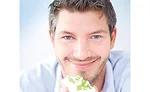 Man Smiling While Eating Healthy Snack