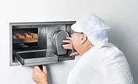 Baker Checking on Baked Goods