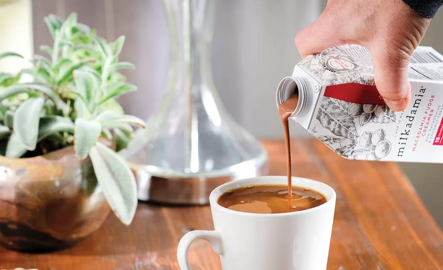 Milkadamia Being Poured Into Cup of Coffee