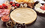 Pizza Dough Surrounded by Toppings