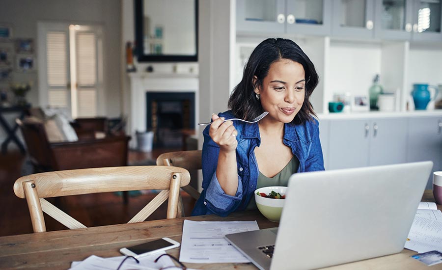 Woman Eating While Working From Home