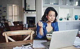Woman Eating While Working From Home
