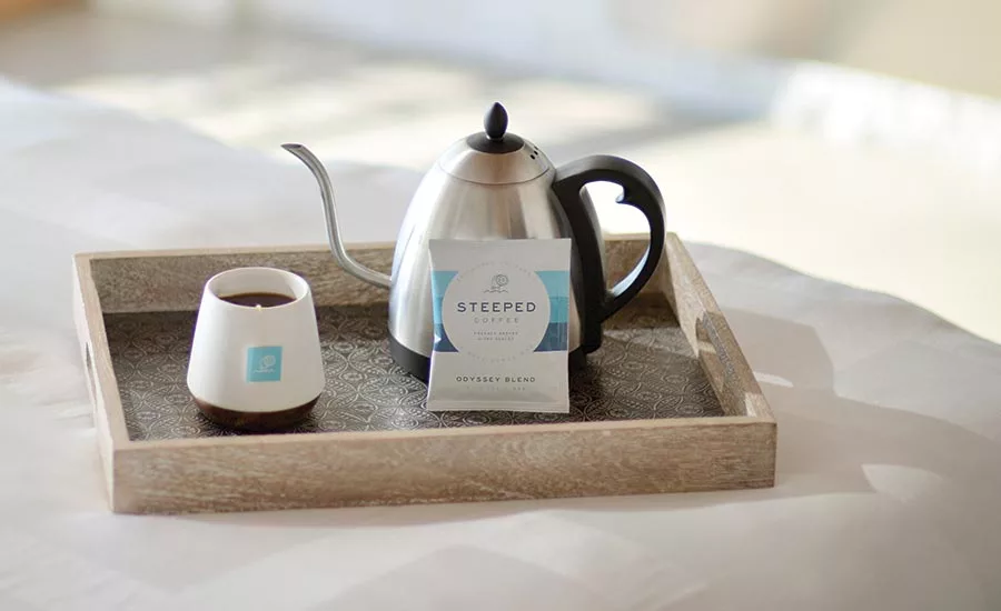 Cup, Kettle, and Packet of Steeped Coffee