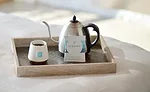 Cup, Kettle, and Packet of Steeped Coffee