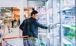 Woman Looking at Refrigerated Beverages