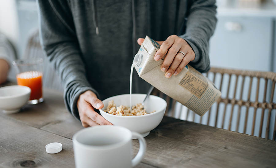 Non-Dairy Milk Being Poured on Cereal