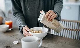 Non-Dairy Milk Being Poured on Cereal