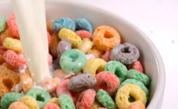 Milk Being Poured Into Bowl of Colorful Cereal