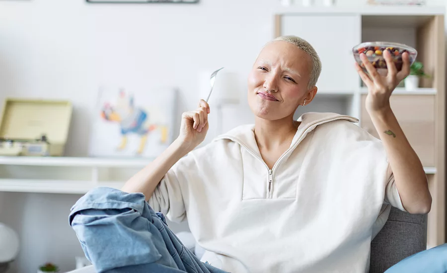 Woman smiling and eating a snack