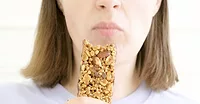 women eating protein granola bar