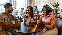 Group socializing in coffee shop