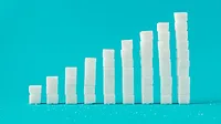 A column chart made of sugar cubes with a blue background.