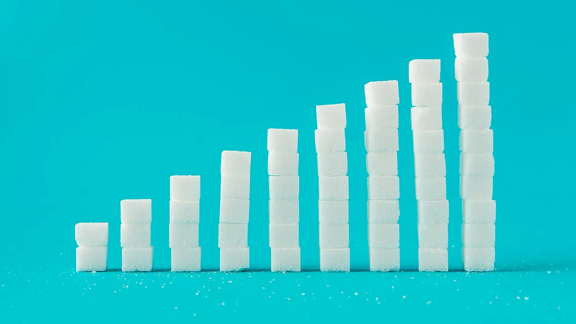 A column chart made of sugar cubes with a blue background.
