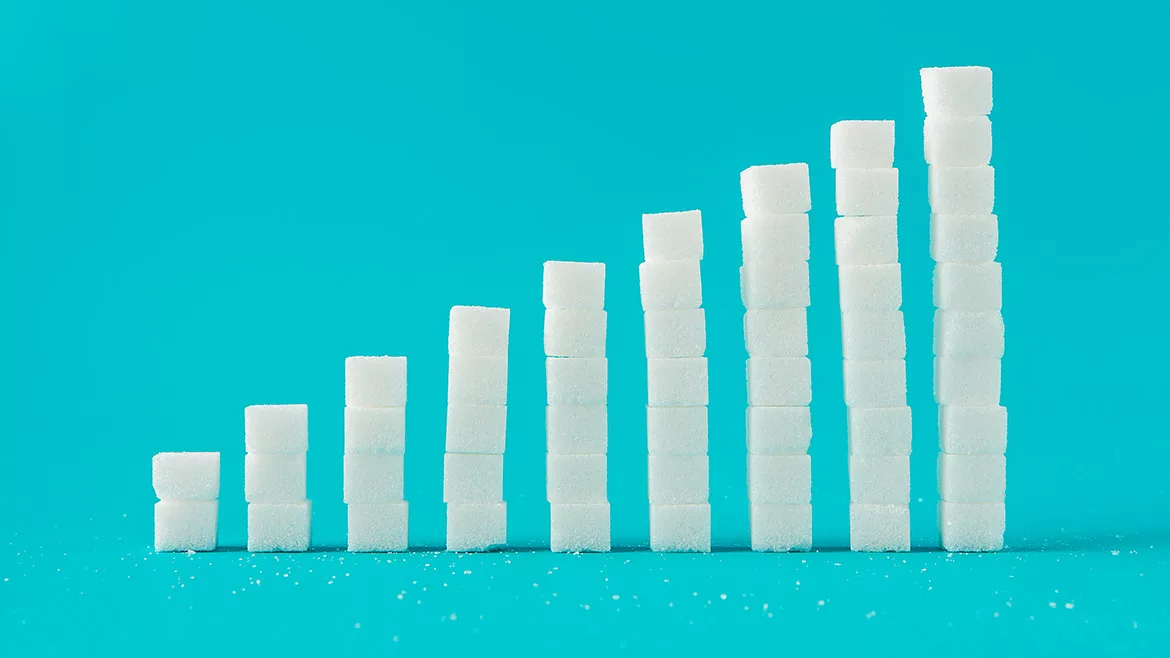 A column chart made of sugar cubes with a blue background.