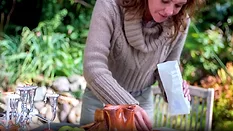 A woman using organic edible flowers.