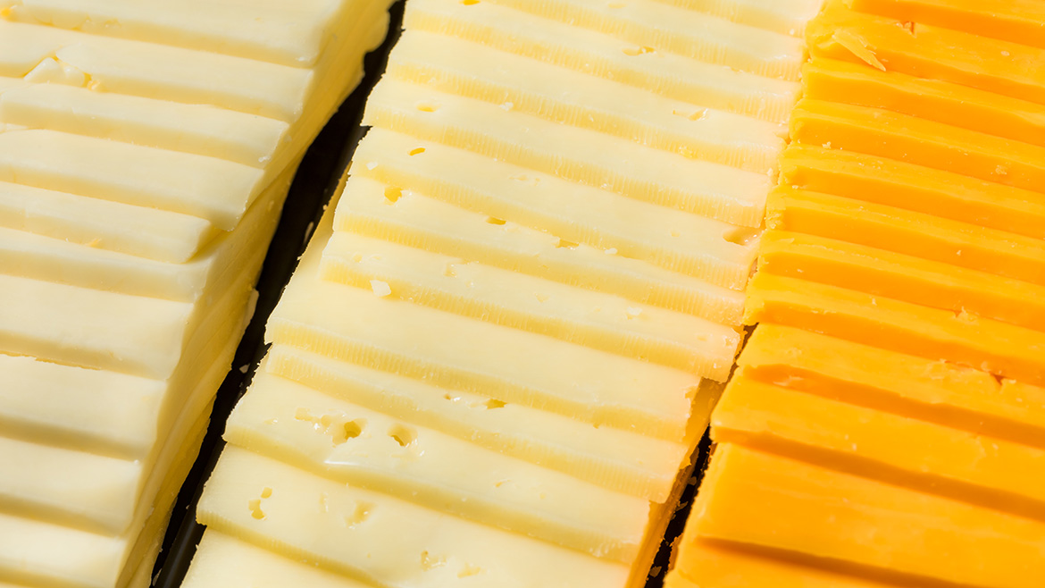 Rows of cheese slices in different varieties.