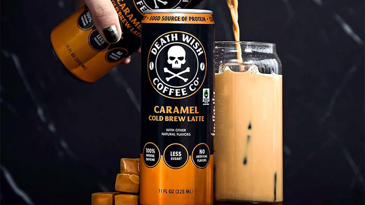 Death Wish Coffee Caramel Cold Brew Latte being poured from a can into a glass with ice, surrounded by caramels.