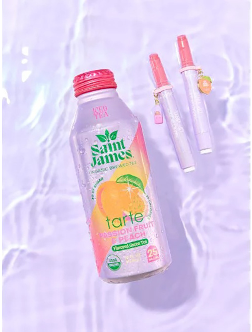 A Saint James Tarte iced tea bottle and two Tarte lip products with peach charms float on water.