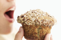 woman eating muffin