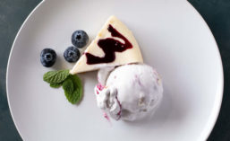 Scoop of Ice Cream and Slice of Cheesecake on Plate
