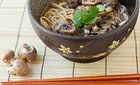 Mushrooms Next to Bowl of Mushroom Miso Ramen
