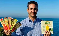 Simon Sacal, CEO of Solely Inc, Holding Two of Solely's Snack Products