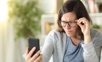 Woman Wearing Glasses While Looking at Phone