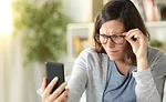 Woman Wearing Glasses While Looking at Phone